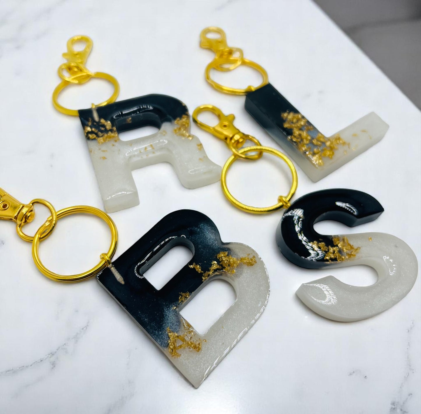 White and Black with Gold Flakes Resin Keychains